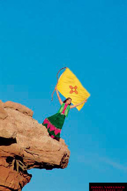 Woman on Cliff with Flag | Santa Fe Chamber of Commerce | Santa Fe, NM